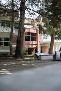 An international student exploring a university campus with a backpack.