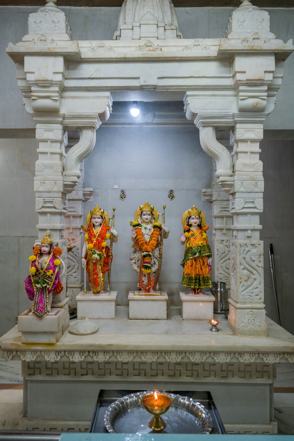 a group of statues sitting on top of a white table