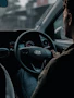 Focused young man behind the wheel, confidently practicing driving skills.