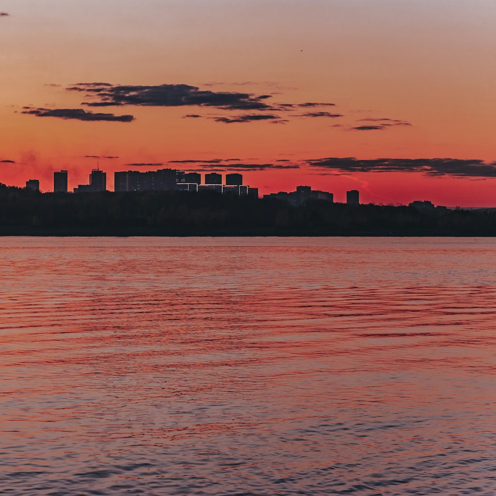 a large body of water with a city in the background