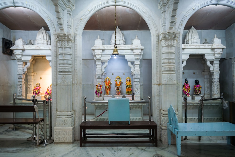 a room with a blue bench and a white wall