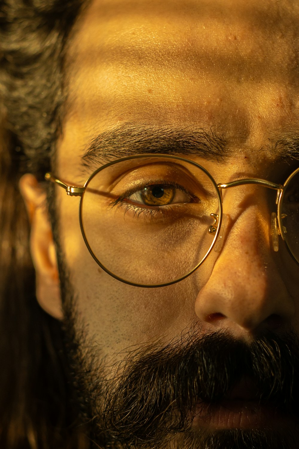 a close up of a man wearing glasses