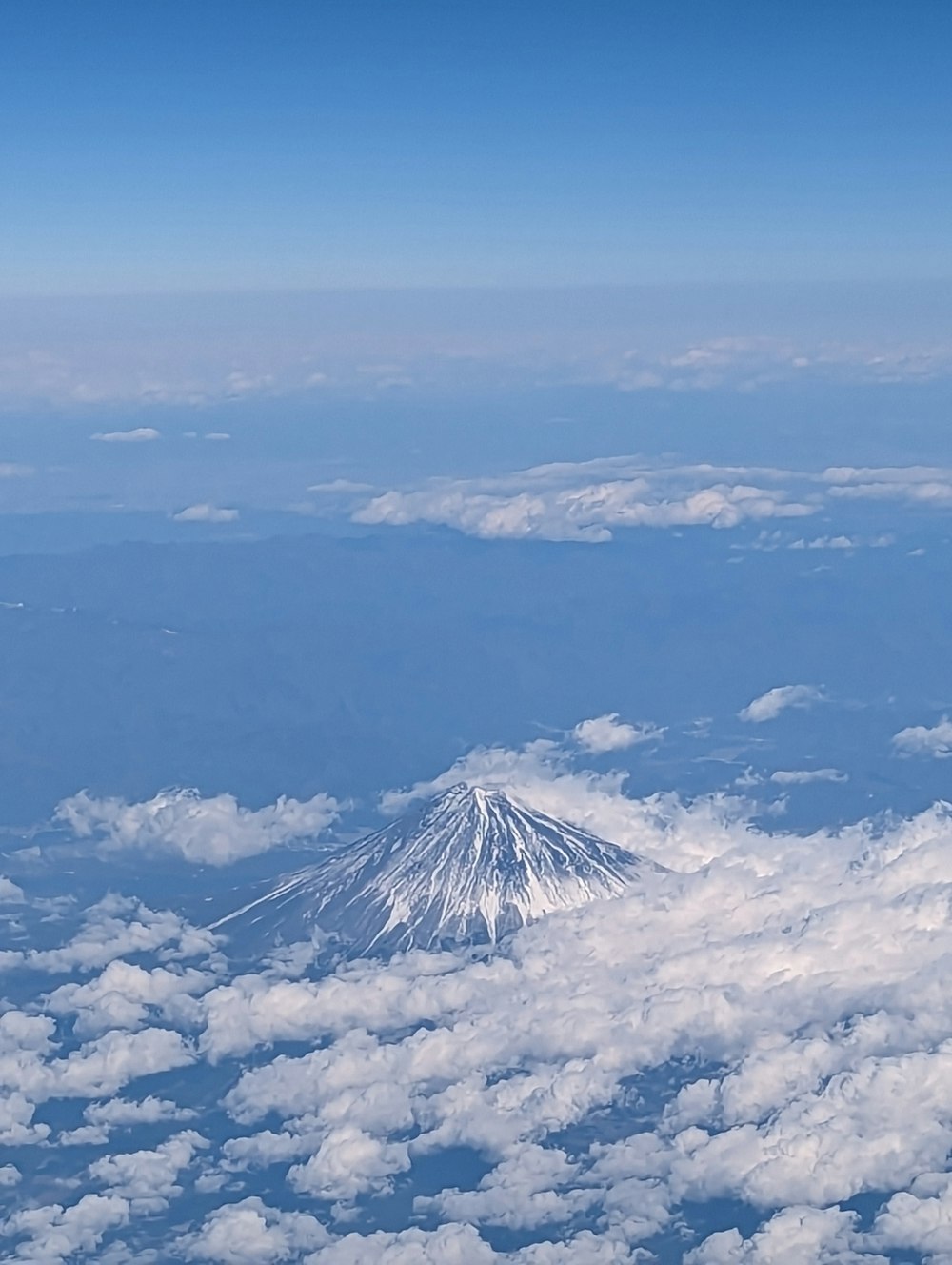 Una vista de una montaña cubierta de nieve desde un avión
