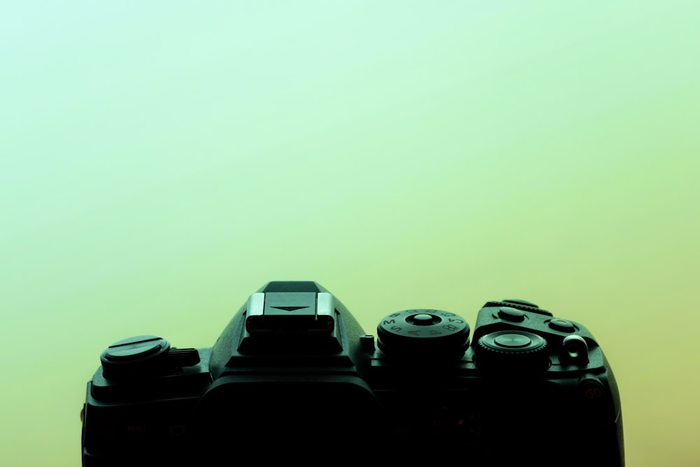 a close up of a camera with a green background