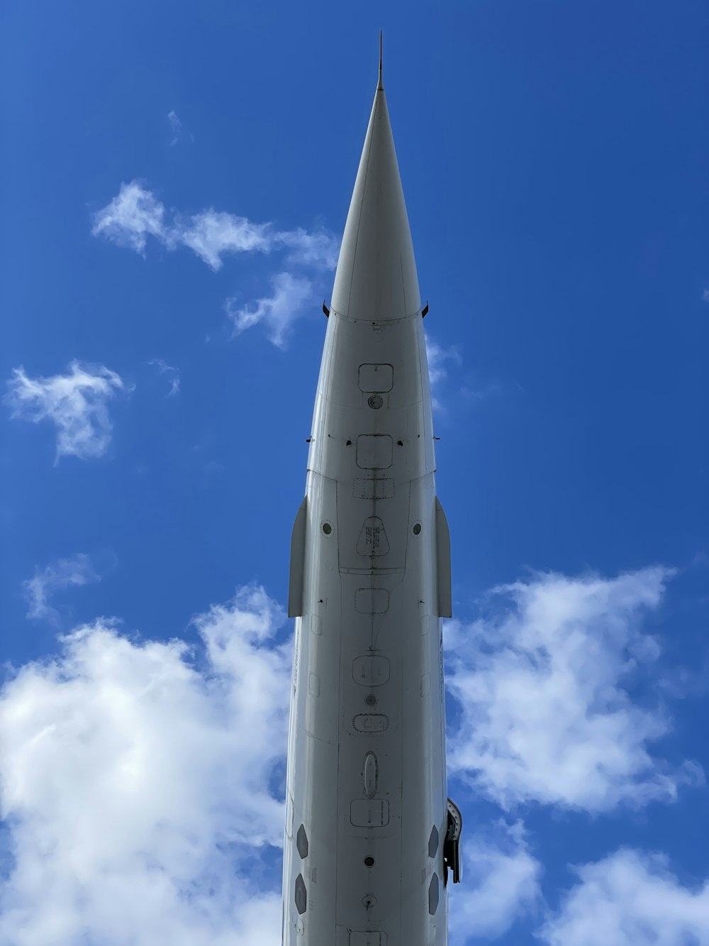 a large jetliner flying through a blue cloudy sky