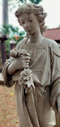 A serene portrait of a child holding a flower in a sunlit garden