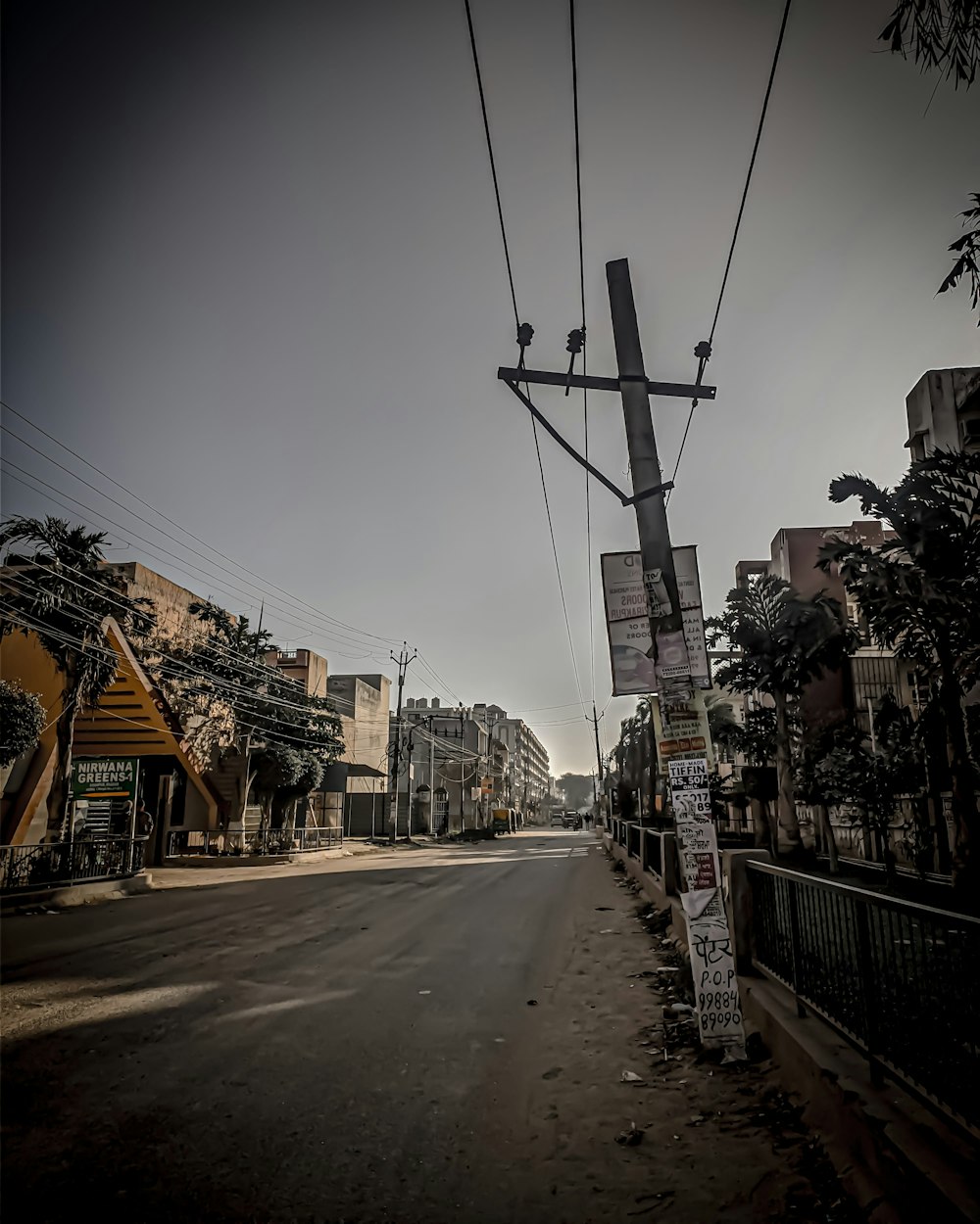 an empty street with power lines above it