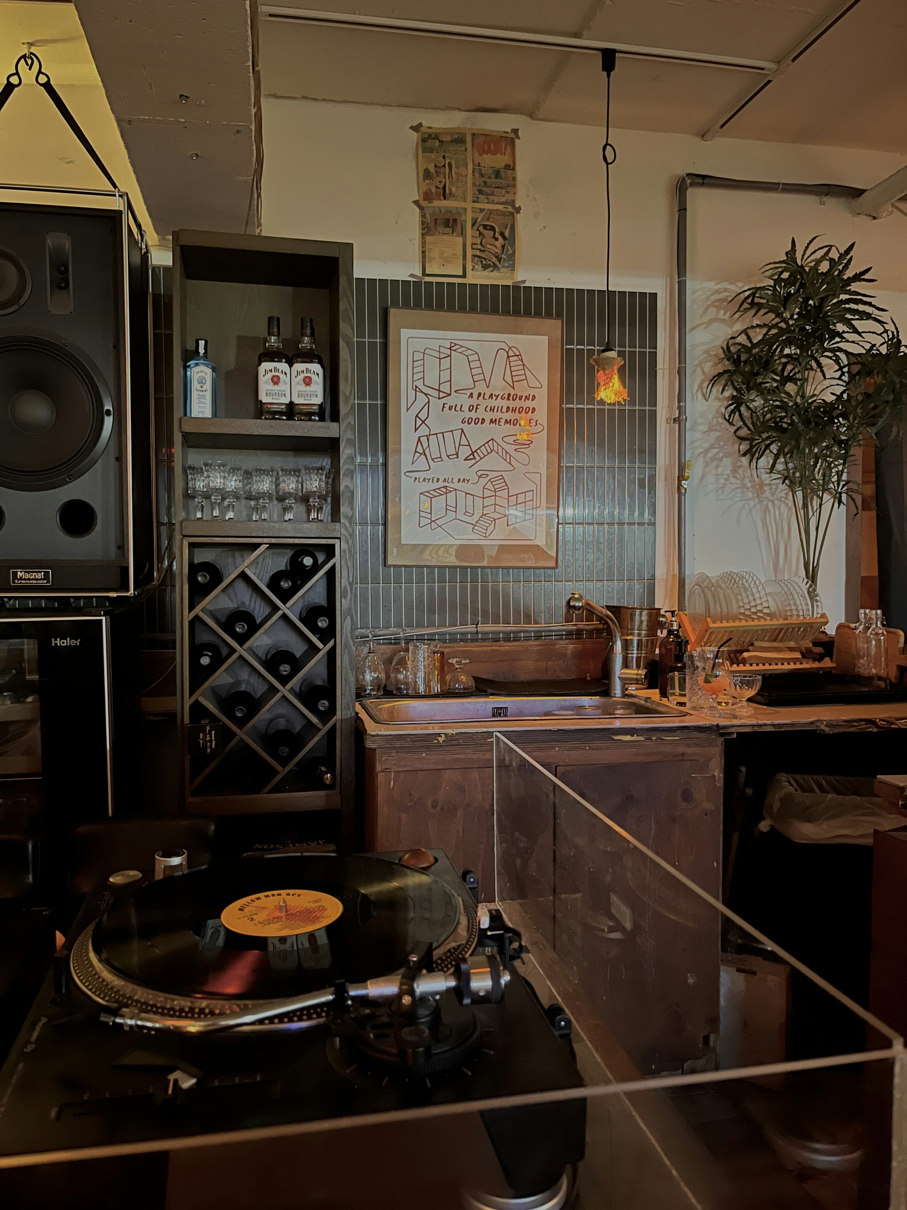 Close-up of vinyl record being placed on turntable in a bar setting