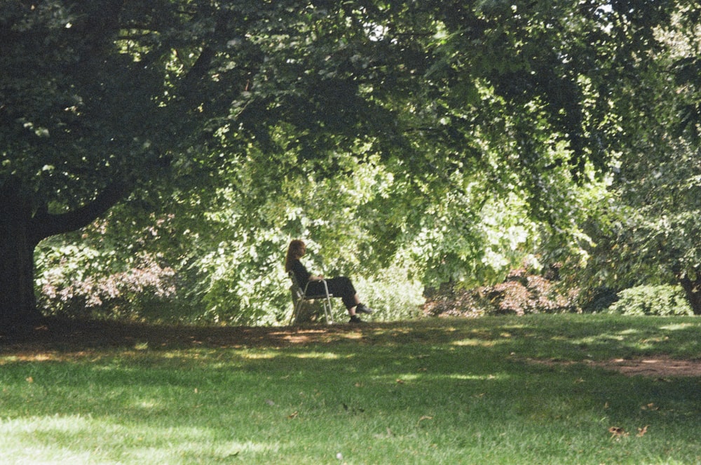 a woman walking a dog in a park