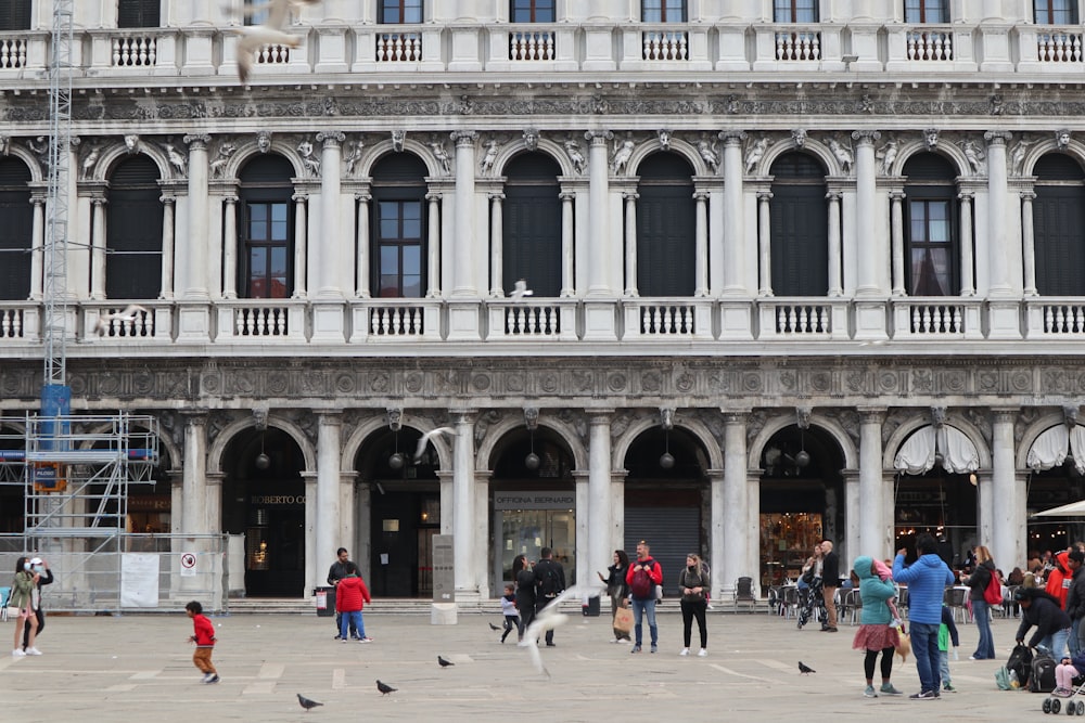 a group of people standing in front of a building