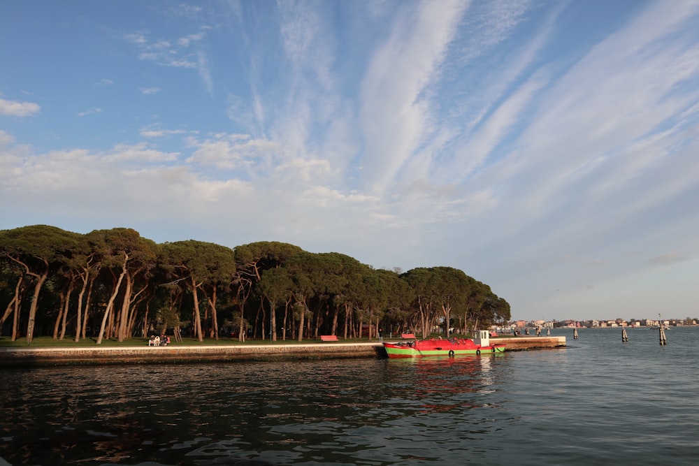 a body of water with trees and a dock