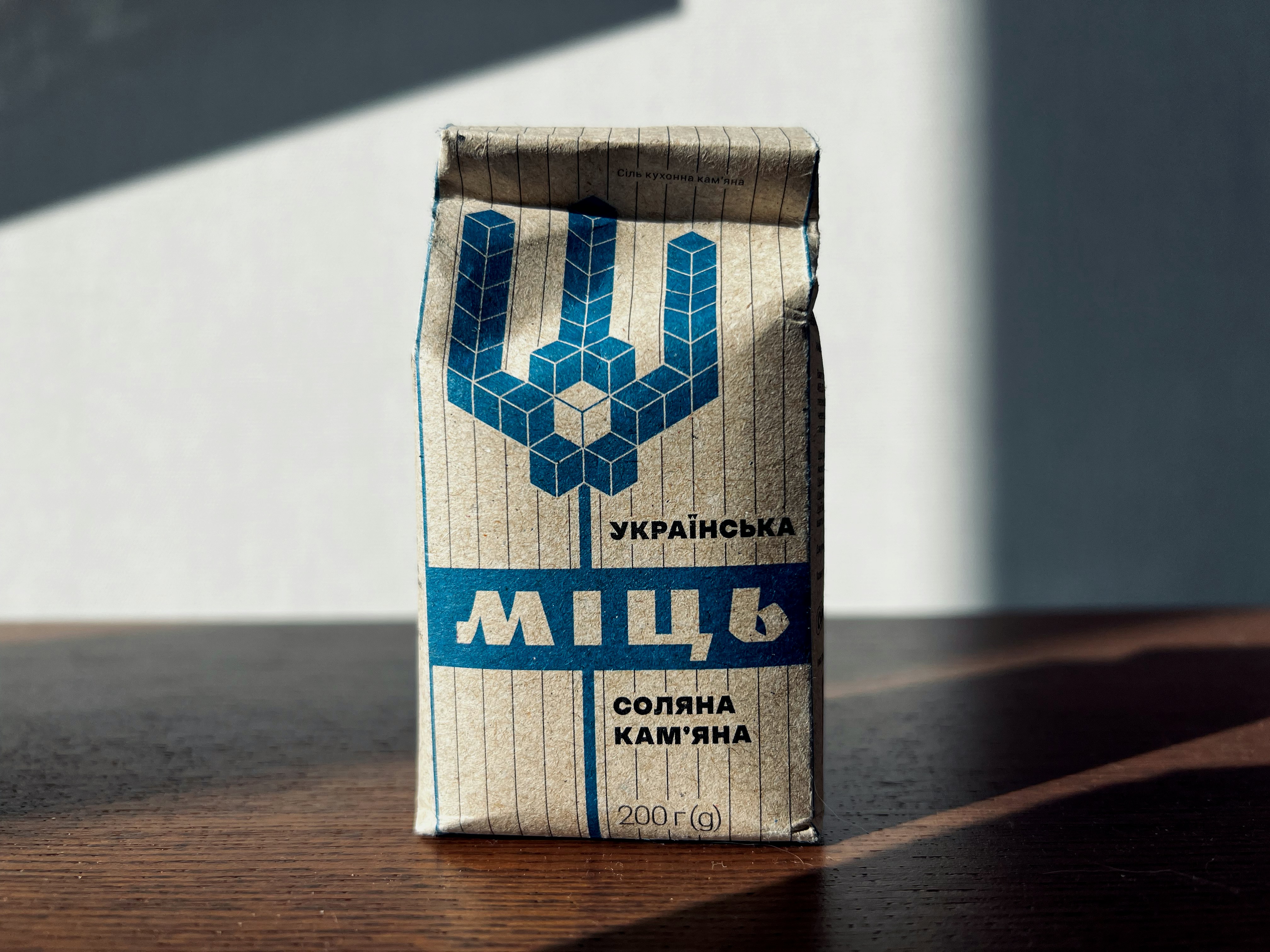 a bag of coffee sitting on top of a wooden table