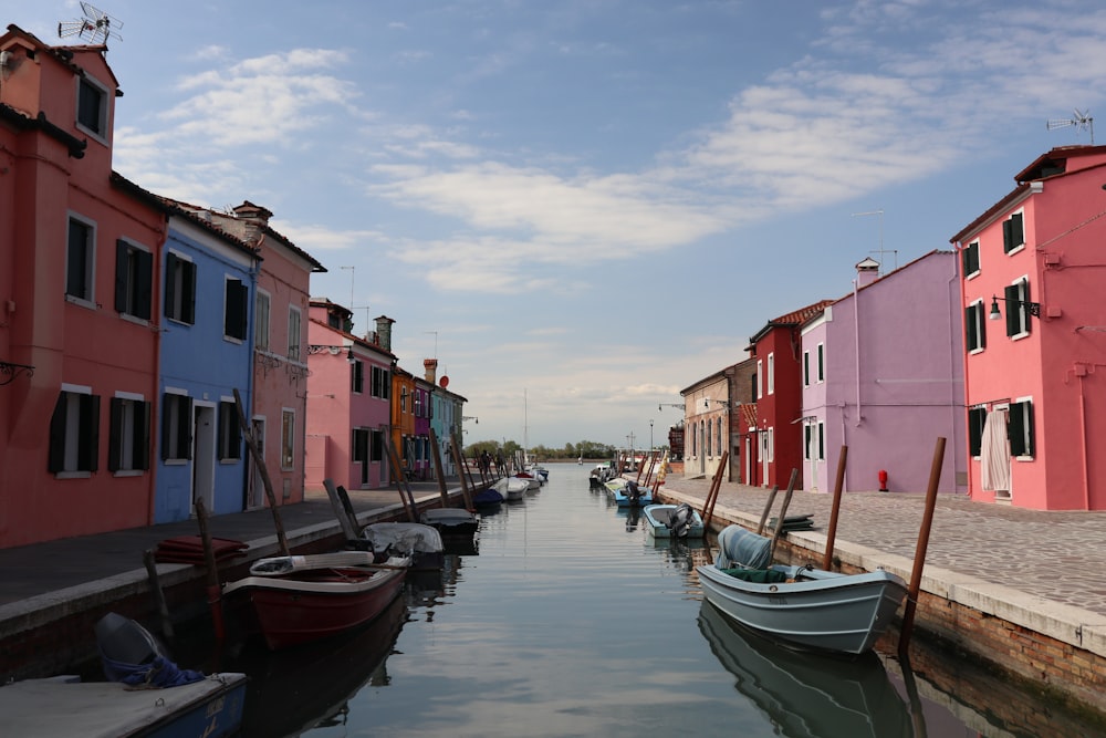 a row of boats sitting next to each other on a body of water