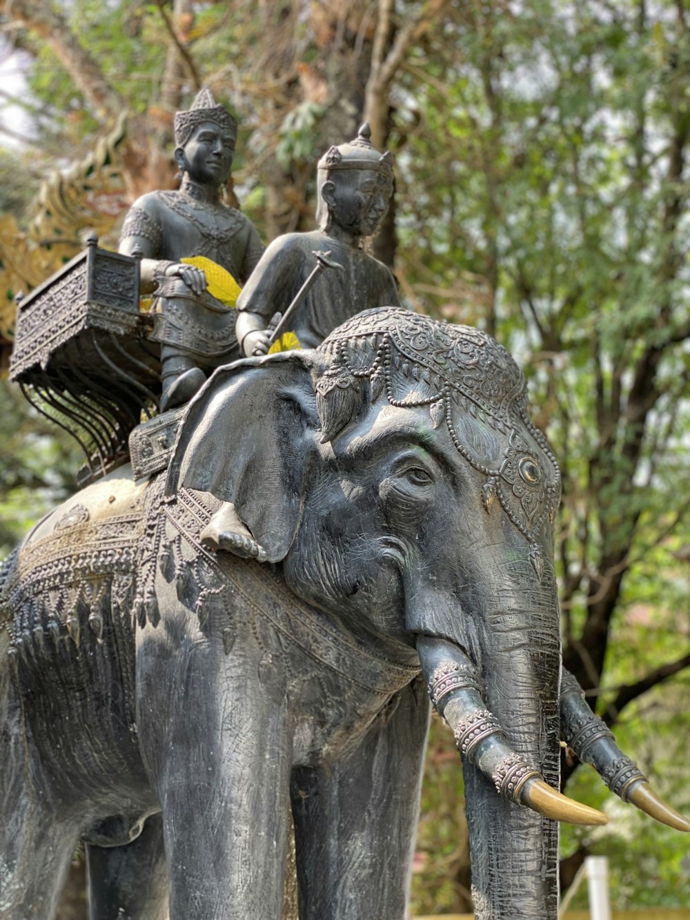 a statue of a man riding on the back of an elephant