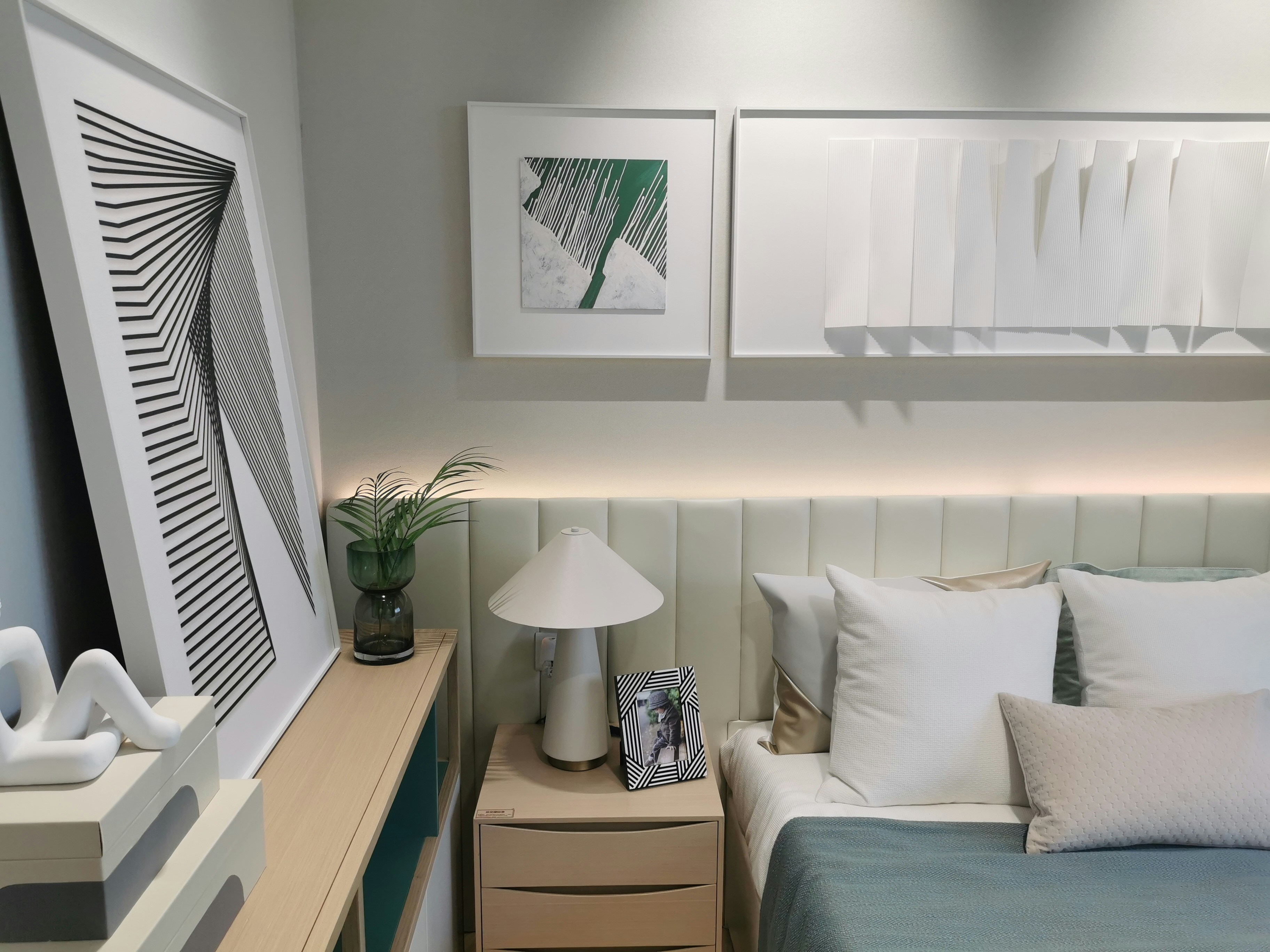 a bed room with a neatly made bed and a night stand