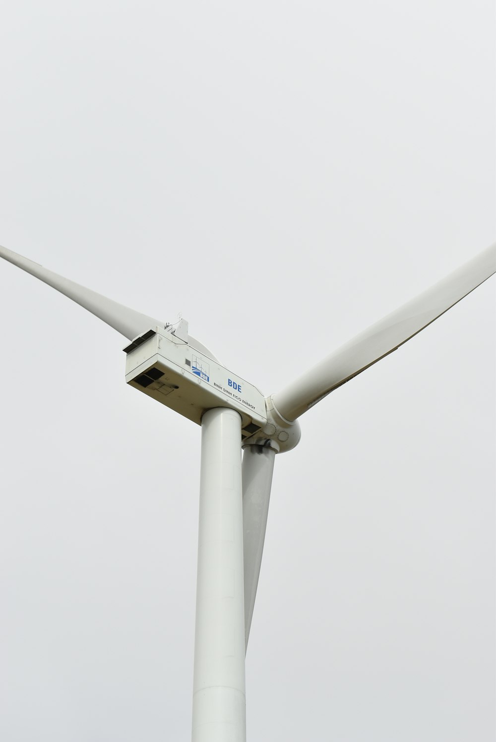 a close up of a wind turbine on a cloudy day