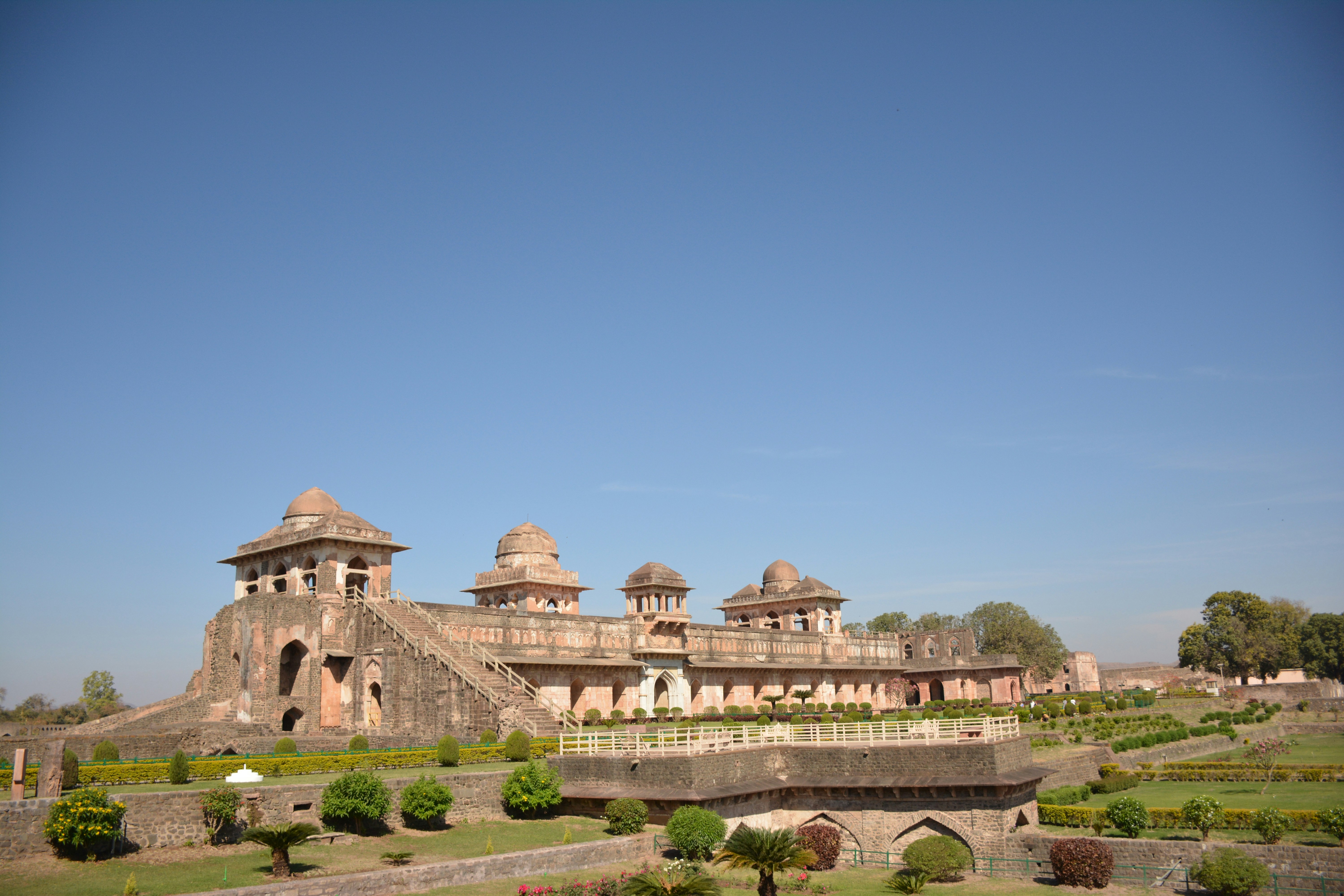 a large building sitting on top of a lush green field