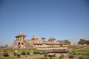 a large building sitting on top of a lush green field
