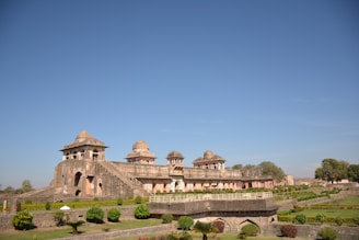 a large building sitting on top of a lush green field