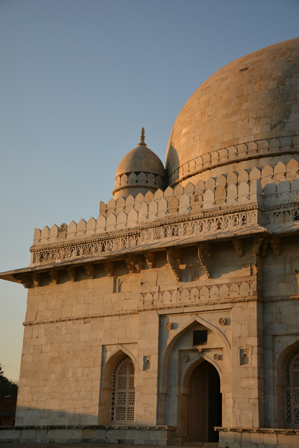 a stone building with a dome and a door