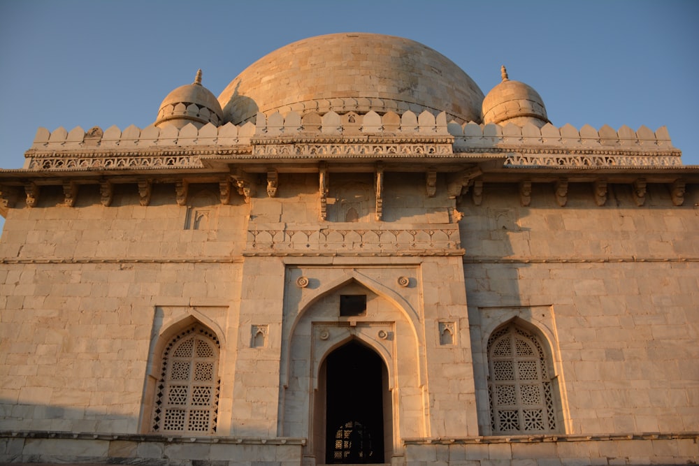 a large stone building with two domes on top of it