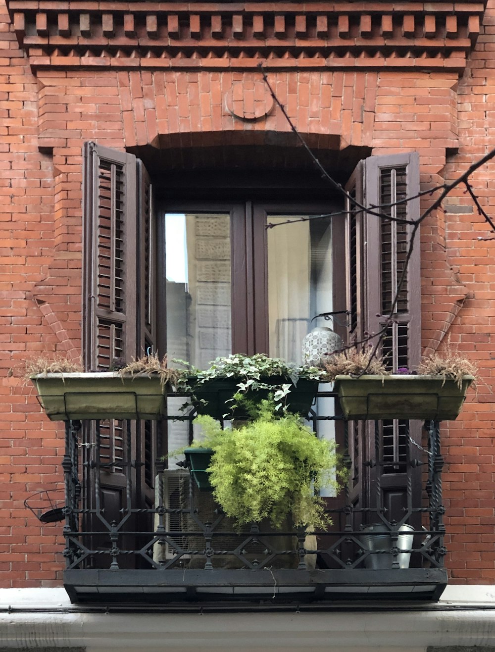 a balcony with a potted plant on it