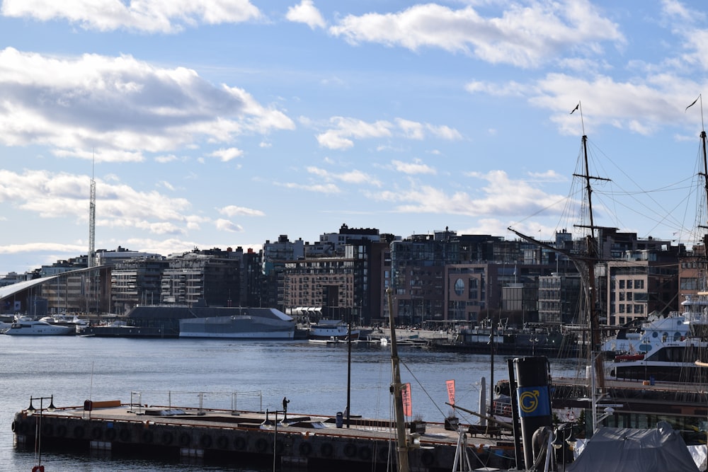 a harbor filled with lots of boats next to tall buildings