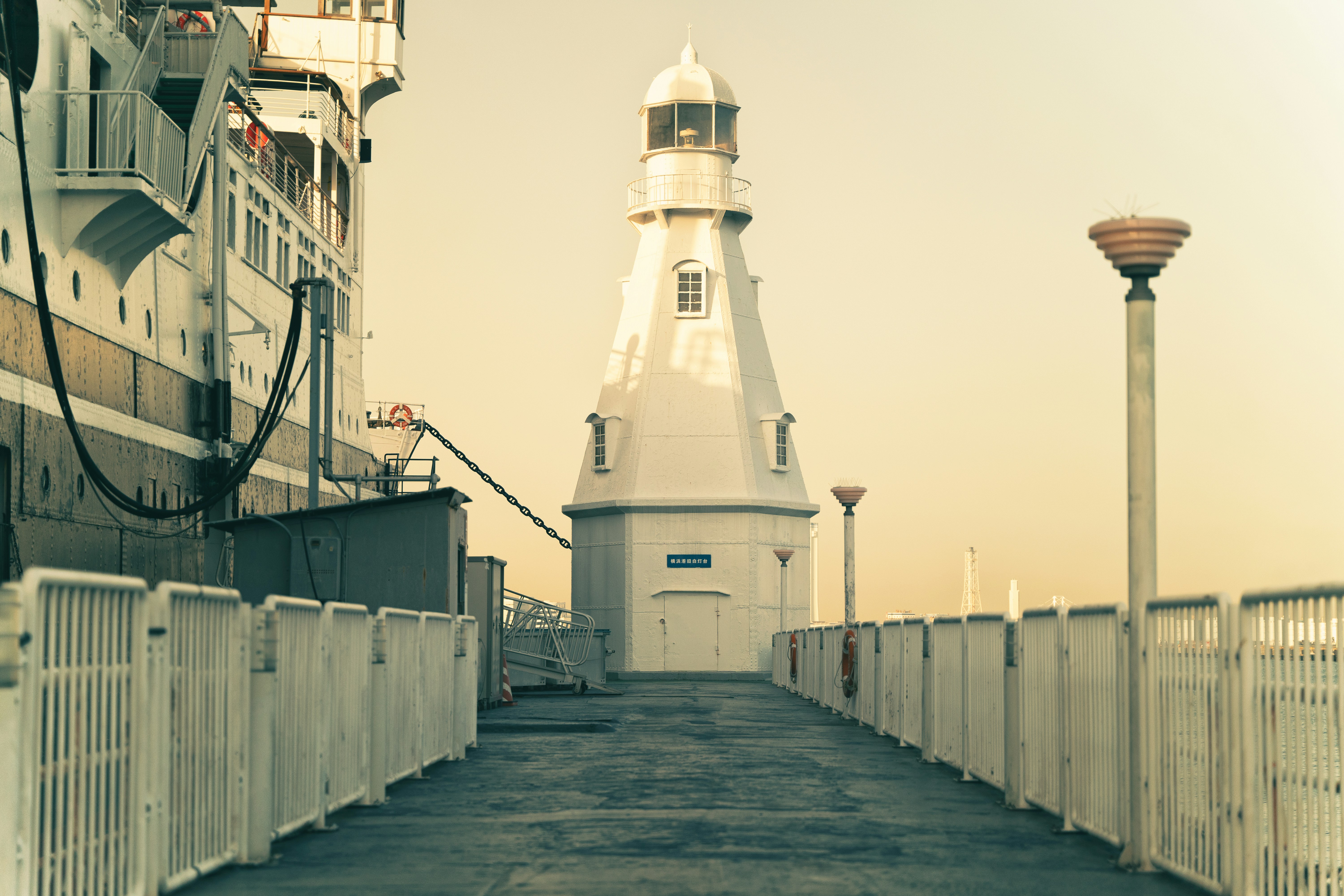 A lighthouse on the side of a pier photo – Free Lighthouse Image on ...