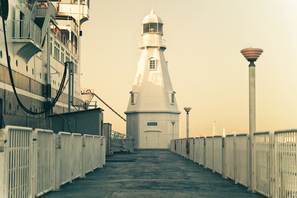 a lighthouse on the side of a pier