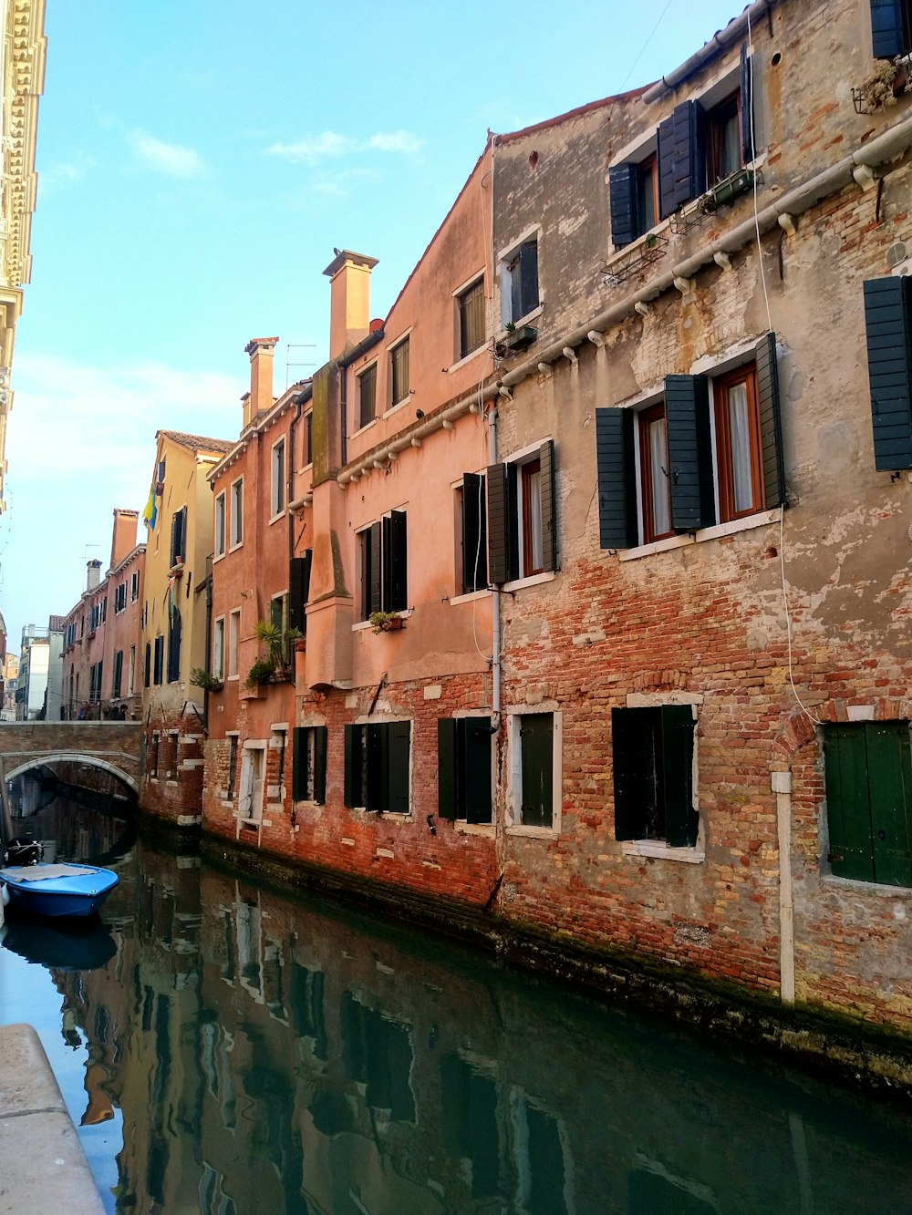 a boat is floating down a canal in a city