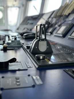 Close-up of a ship's main engine control panel with gauges and switches.