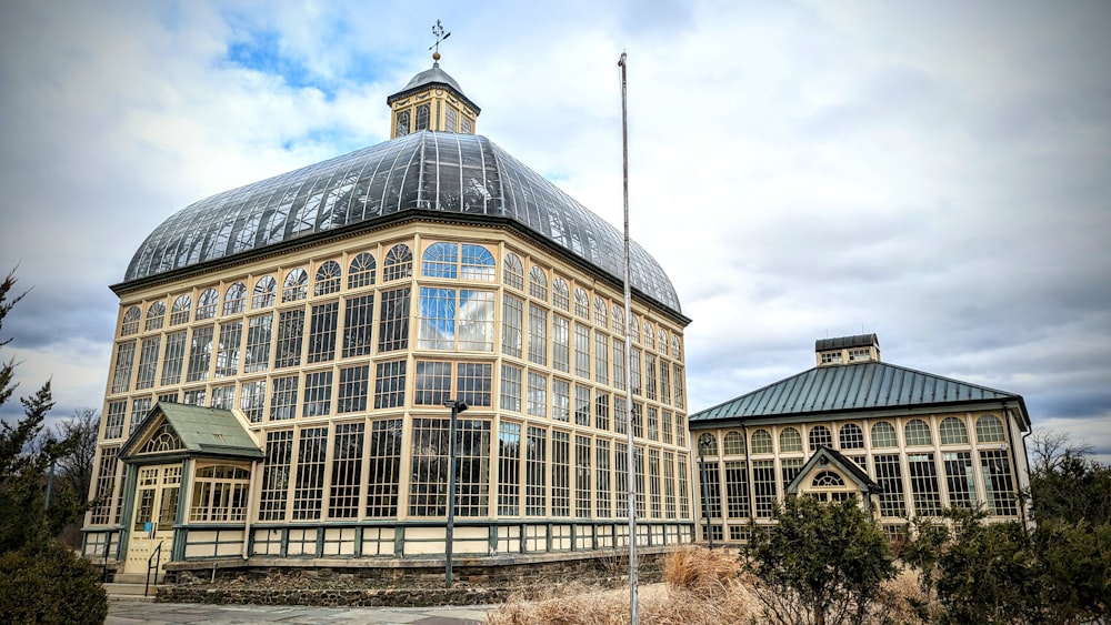 a large glass building with a dome on top of it