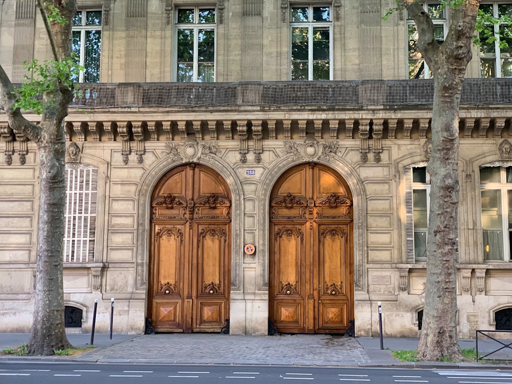 a couple of large wooden doors in front of a building