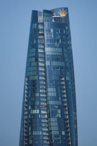 Sleek, modern office building exterior at dusk representing Crownmont Capital Group’s global presence.