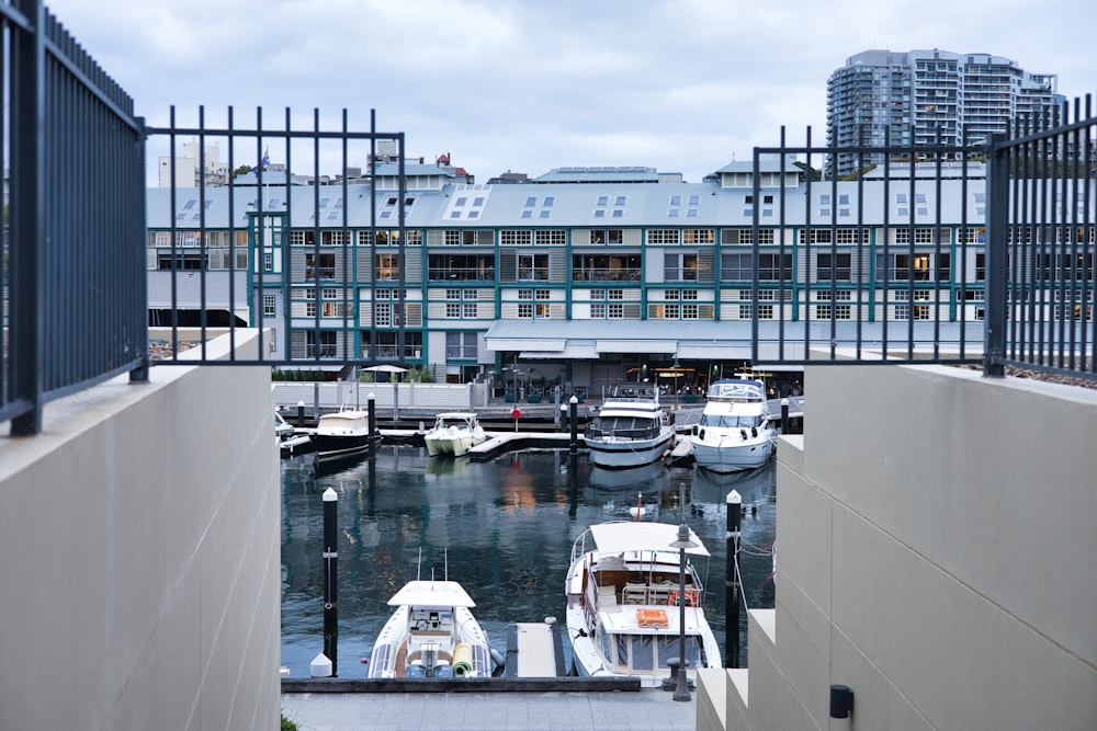 several boats are docked in the water near a building