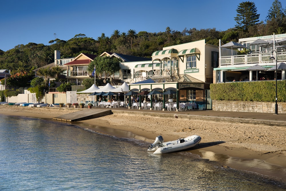 an inflatable boat on the shore of a beach