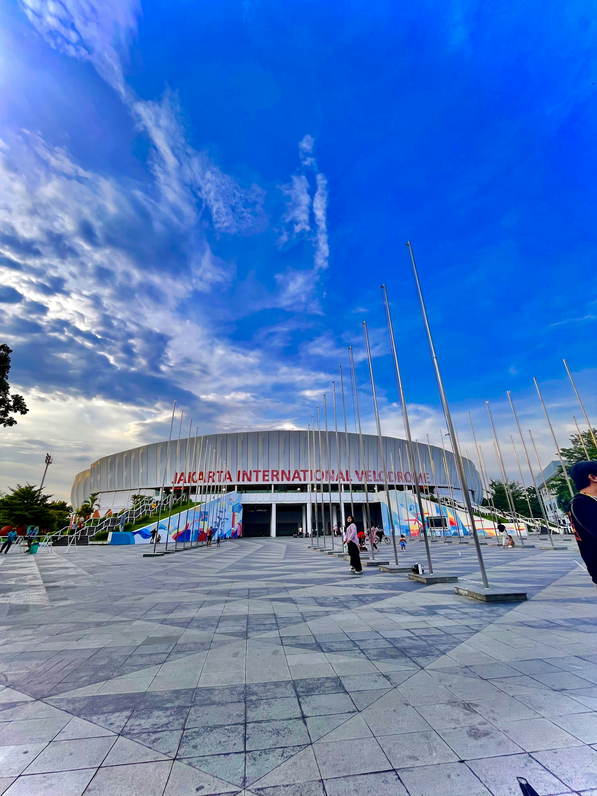 woman wearing yellow long-sleeved dress under white clouds and blue sky during daytime