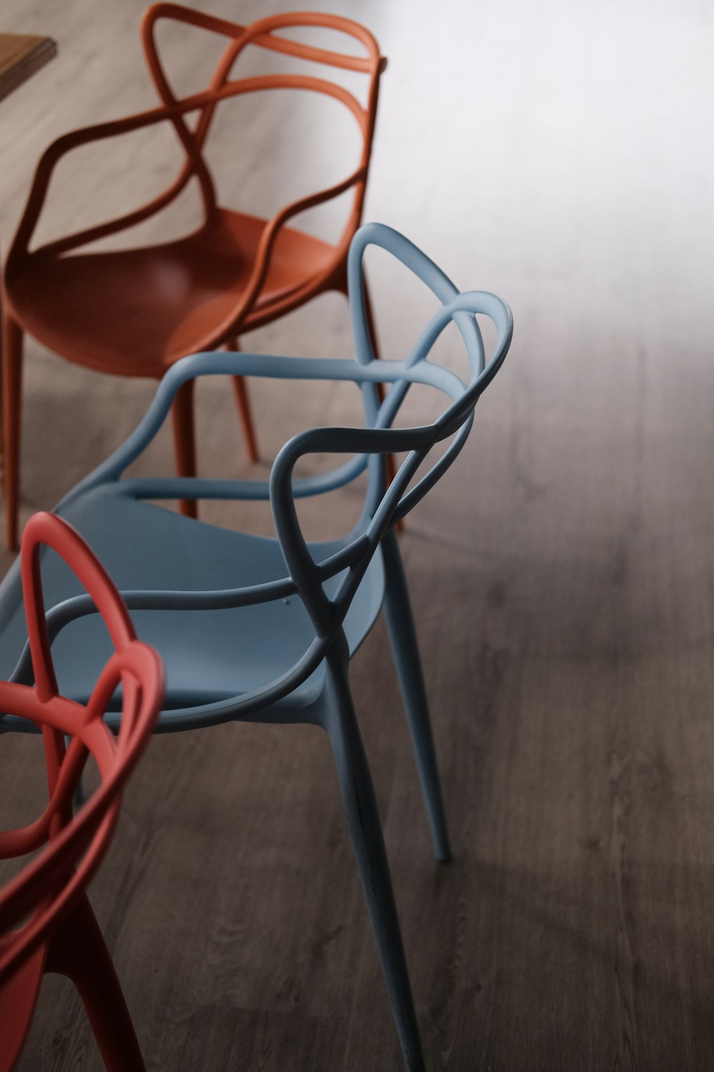 a row of chairs sitting on top of a wooden floor