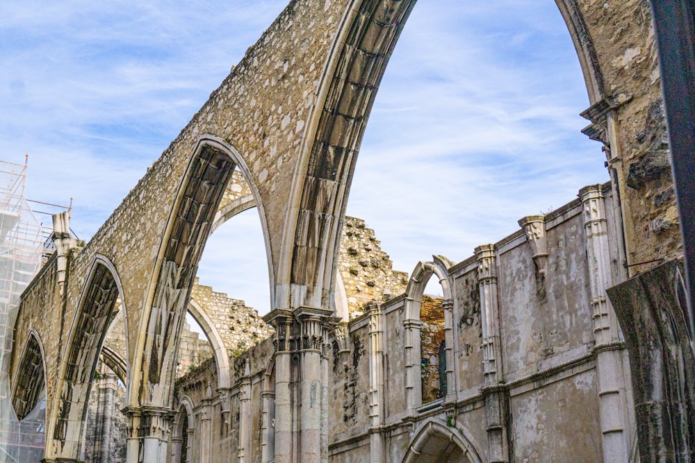 a large cathedral with arches and a blue sky in the background