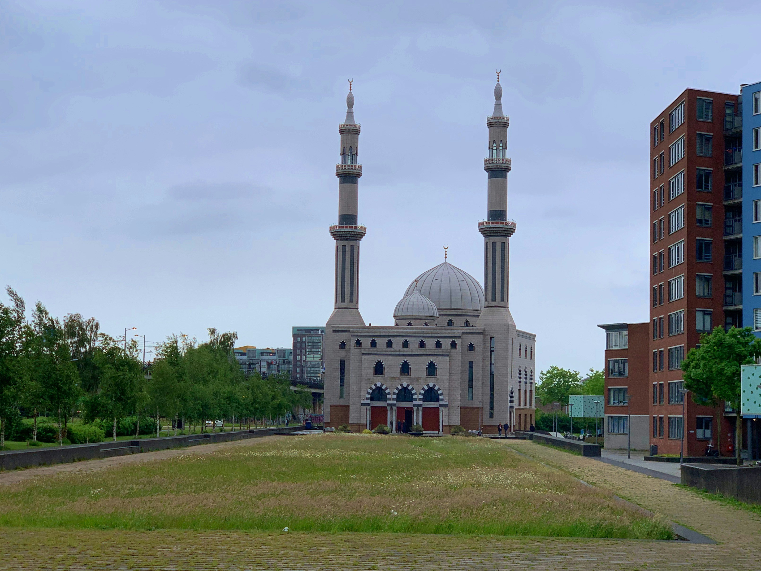 a large building with two towers in the middle of a field