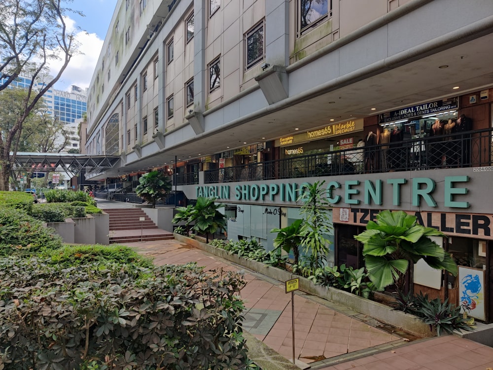 a building that has a lot of plants in front of it