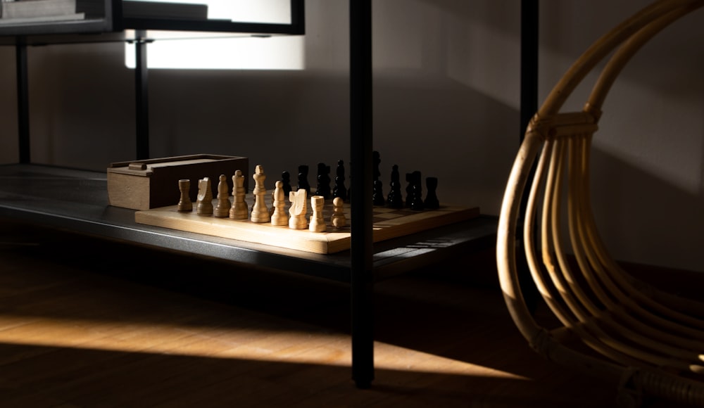 a wooden chess set sitting on top of a wooden table