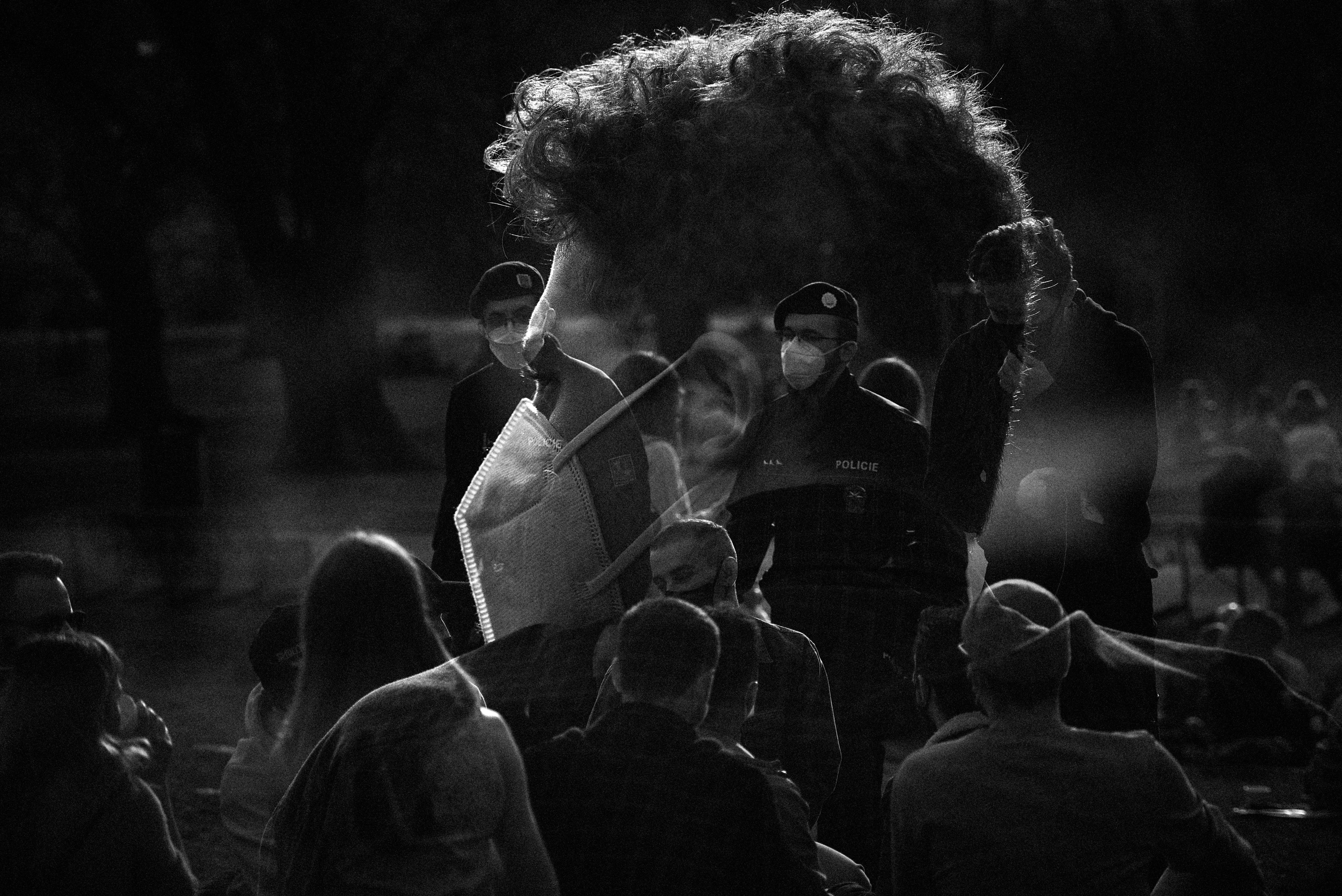 a group of people standing around each other