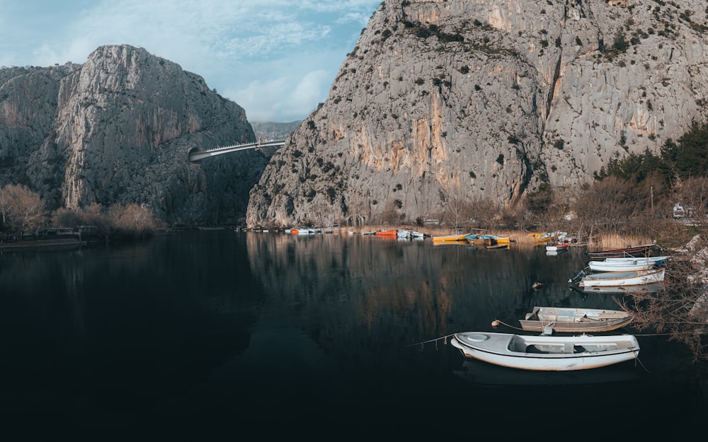 a group of boats floating on top of a lake