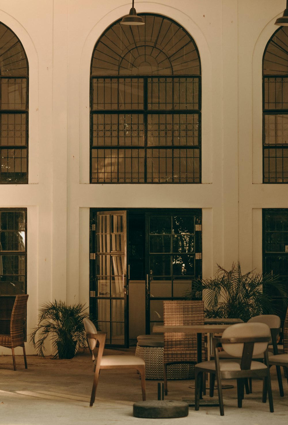 a group of chairs and tables in front of a building