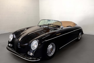 A sleek vintage convertible parked under soft sunlight, showcasing timeless elegance.