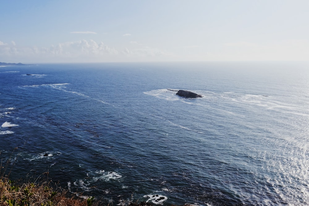 a body of water with a small boat in the middle of it