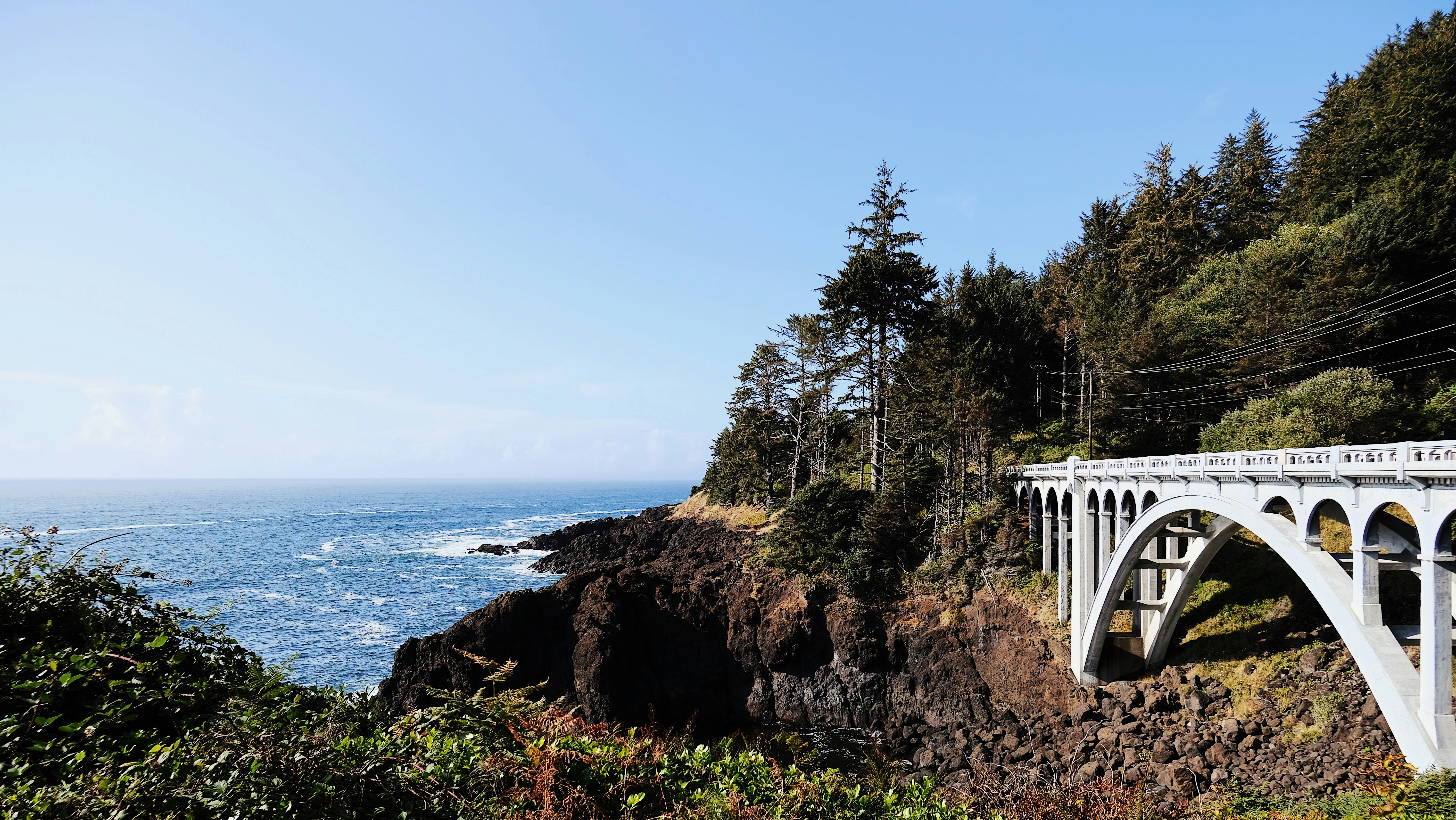 a white bridge over a large body of water