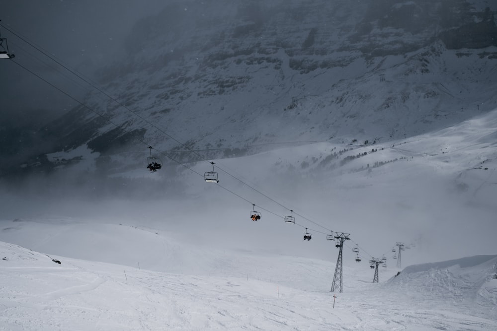 a ski lift going up a snowy mountain