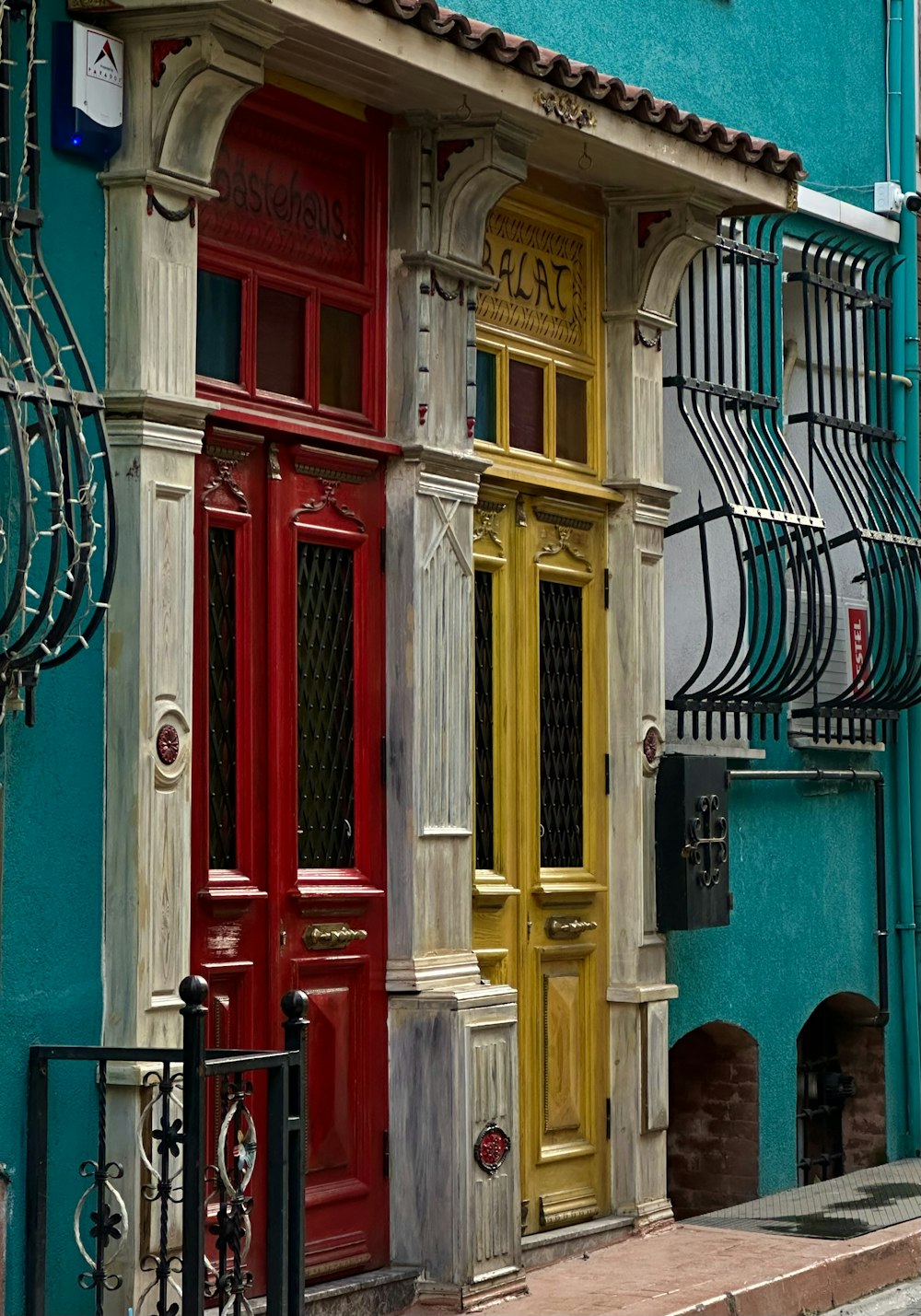 a blue building with a red and yellow door